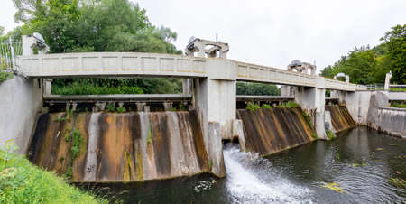 Kolbudy, pomorskie / Poland - July, 31, 2020: Weir on the Radunia River. A dam that regulates the river level. Summer season.のeditorial素材