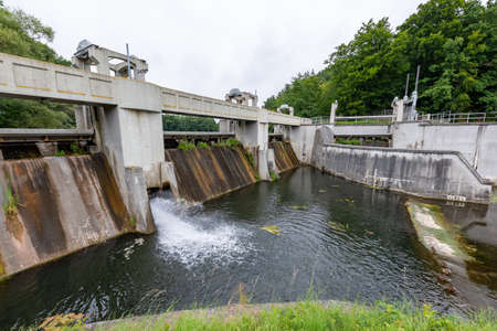 Kolbudy, pomorskie / Poland - July, 31, 2020: Weir on the Radunia River. A dam that regulates the river level. Summer season.のeditorial素材