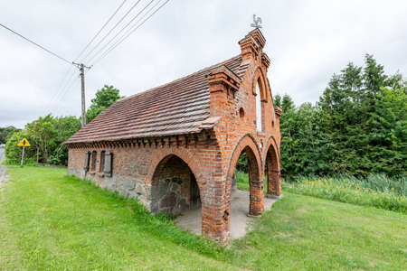 Wilcze Blota, Pomorskie / Poland - July, 31, 2020: Building of an old forge in a small village. An old brick building for a craftsman. Summer season.のeditorial素材
