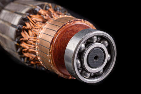 Electric motor rotor. Parts for the electric motor that drives the saw. Dark background.の写真素材
