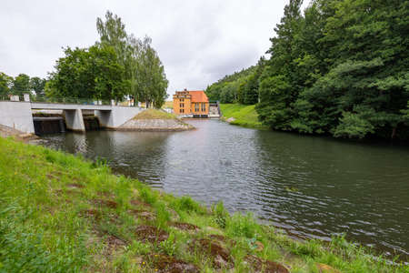 Lapino, pomorskie / Poland - July, 31, 2020: Old hydropower plant. Hydrotechnical structure in Central Europe. Summer season.のeditorial素材
