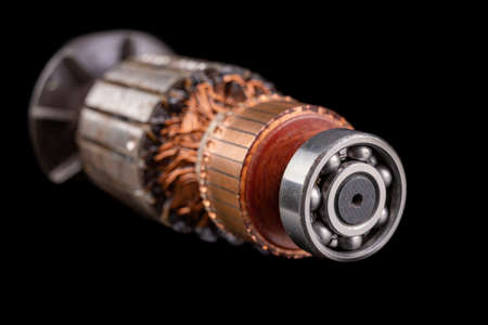 Electric motor rotor. Parts for the electric motor that drives the saw. Dark background.の写真素材