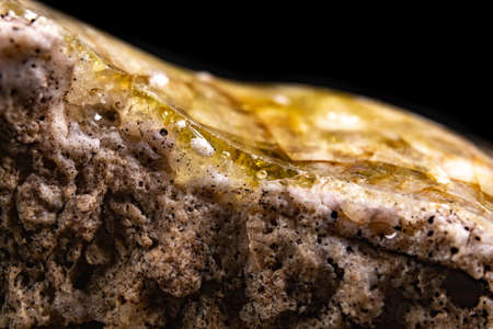 Partially molten quartz. Dirty vitrified glass material. Dark background.の写真素材