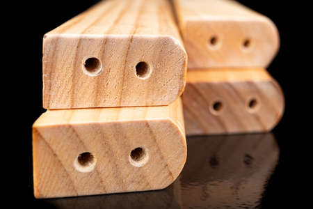 The wood is processed and varnished in a carpentry shop. Ready-made elements for furniture assembly. Dark background.の写真素材