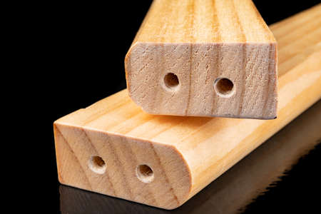 The wood is processed and varnished in a carpentry shop. Ready-made elements for furniture assembly. Dark background.の写真素材