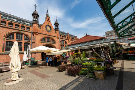Gdansk, pomorskie / Poland - August, 8, 2020: Historic market hall in Gdansk. Historic tenement houses in the city of Central Europe. Summer season.のeditorial素材