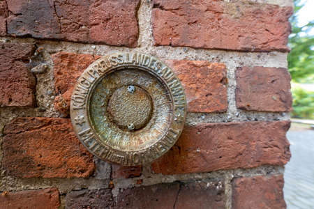 Sianow, pomorskie / Poland - August, 14, 2020:. Metal height sign embedded in the wall. Old height markings. Summer season.のeditorial素材