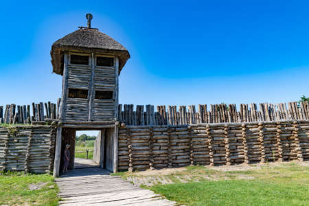 Biskupin, Kujawsko-pomorskie / Poland - August, 16, 2020: An old wooden pre-Slavic settlement. Thatched wood huts. Summer season.のeditorial素材