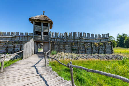 Biskupin, Kujawsko-pomorskie / Poland - August, 16, 2020: An old wooden pre-Slavic settlement. Thatched wood huts. Summer season.のeditorial素材