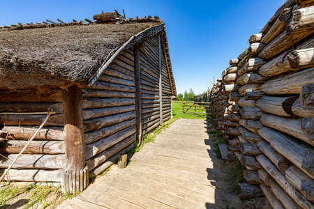Biskupin, Kujawsko-pomorskie / Poland - August, 16, 2020: An old wooden pre-Slavic settlement. Thatched wood huts. Summer season.のeditorial素材