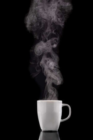 Coffee cup and steam. Freshly brewed coffee in a white ceramic mug. Dark background.の写真素材