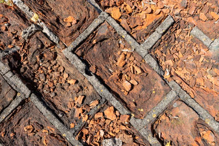 Broken brick on the building. Wall elevation damaged by frost. Summer season.の写真素材