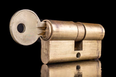 A solid lock and key for a household door.の写真素材