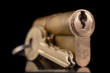 A solid lock and key for a household door.の写真素材