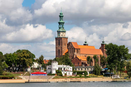 Chelmza, Kujawsko-pomorskie / Poland - August, 25, 2020: Historic Church in a Small Town in Central Europe. Christian temple in the city center by the lake. Summer season.のeditorial素材