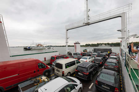Swinoujscie, Zachodniopomorskie / Poland - August, 28, 2020: Ferry crossing the Swina River. Car ferries that transport cars from one bank to the other. Summer season.のeditorial素材