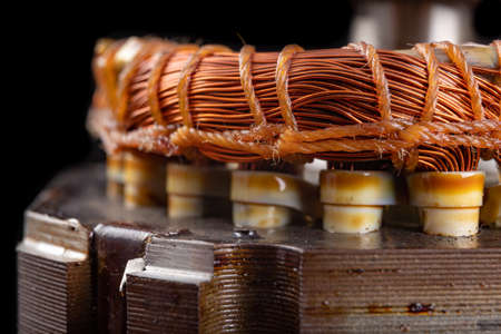 Copper winding of the electric motor. Spare parts for the repair of electrical appliances. Dark background.の写真素材