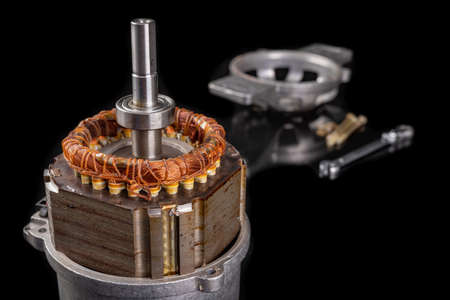 Electric motor disassembled. Repair of electrical appliances. Dark background.の写真素材