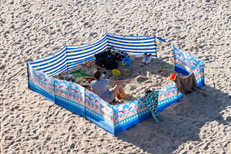 Trzesacz, Zachodniopomorskie / Poland - August, 29, 2020: A screen protecting people resting at the seaside. People enjoying the beach by the sea. Summer season.のeditorial素材