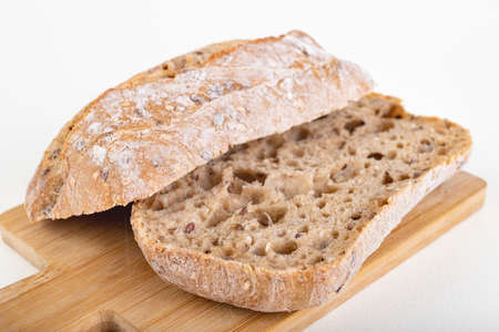 Tasty fresh bun and canned meat. A modest food ration for the prisoner. Light background.