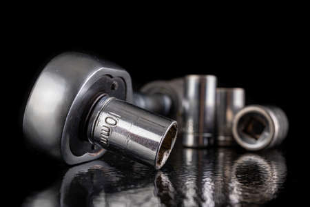 Metal socket wrenches and ratchet. Chromed repair tools in the workshop. Dark background.の写真素材