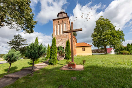 Kwasowo, zahodniopomorskie / Poland - September, 10, 2020: Catholic Church in the center of a small town in Pomerania. Brick Christian temple. Autumn season.のeditorial素材