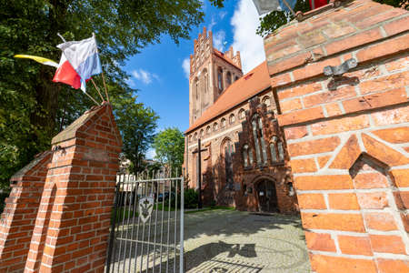 Lebork, pomorskie / Poland - September, 09, 2020: Catholic Church in the center of a small town in Pomerania. Brick Christian temple. Season is autumn.のeditorial素材