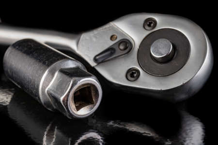Metal socket wrenches and ratchet. Chromed repair tools in the workshop. Dark background.の写真素材