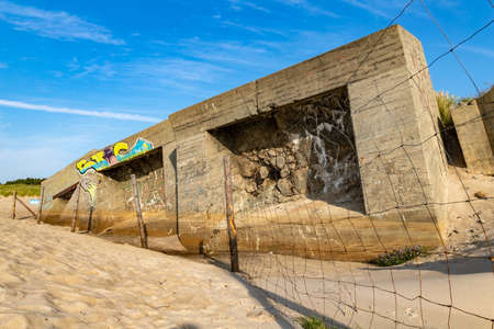Bobolin, zachodniopomorskie / Poland - September, 12, 2020: Old concrete bunkers on the sea beach. Destroyed military fortifications on the coast. Autumn season.のeditorial素材