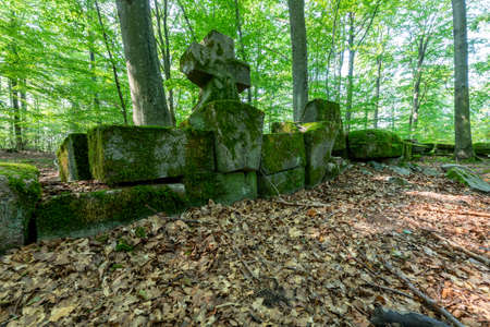 Warcino, pomorskie / Poland - September, 12, 2020: Ruins of the Bismarck mausoleum in a deciduous forest. Old tombstones covered with moss. Autumn season.のeditorial素材