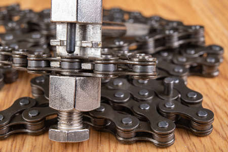 Bicycle chain repair. Special purpose tools in a bicycle workshop. Light background.の写真素材
