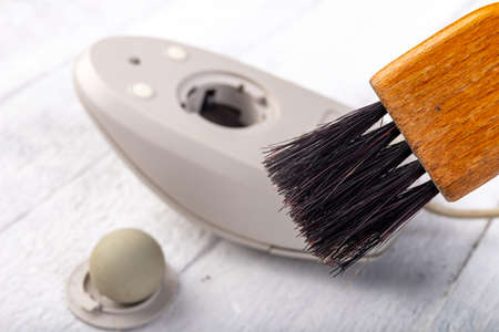 Cleaning with a brush of an old mouse. Office accessories for work. Light background.の写真素材