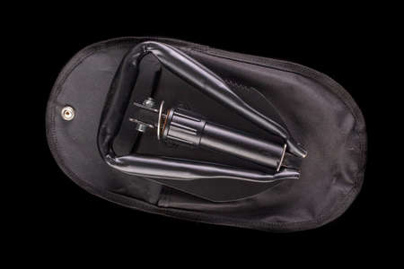 Black military shovel with a cover. Military accessories for personal equipment. Dark background.の写真素材