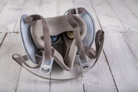 Dust mask for workers on a wooden table. Respiratory protection accessories. White background.の写真素材