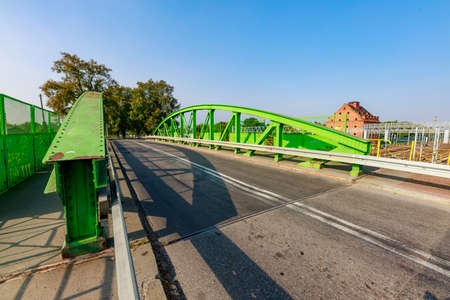 Prabuty, pomorskie / Poland - September, 25, 2020: Metal bridge for cars over the railway line. Pedestrian crossing. Autumn season.のeditorial素材