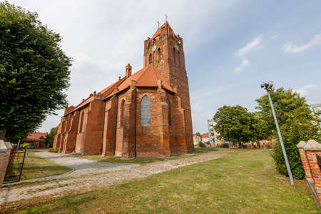 Prabuty, pomorskie / Poland - September, 25, 2020: Catholic Church in the center of a small town in Pomerania. Brick Christian temple. Autumn season.のeditorial素材