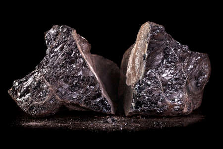 A lump of brown coal. Fuel material for heating single-family houses. Dark background.の写真素材