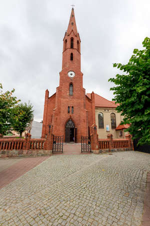 Wyrzysk, wielkopolskie / Poland - October, 01, 2020: Catholic Church in the center of a small town in Pomerania. Brick Christian temple. Autumn season.のeditorial素材
