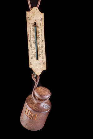 Manual scale and metal weight. Old scale for quick weighing in the marketplace. Dark background.の写真素材