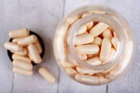 Medical lozenges in a plastic container. Medication for consumption prepared in lozenges. Light background.の写真素材