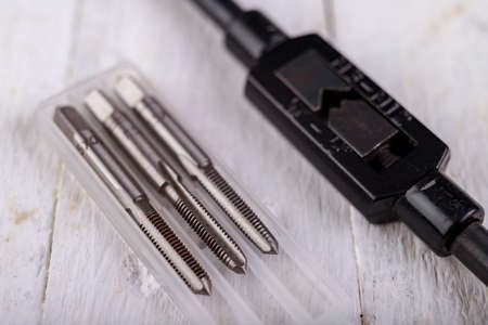 Metal taps prepared for work. Accessories in the locksmith's workshop. Light background.の写真素材