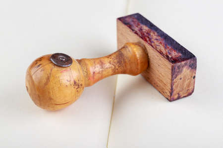 Old wooden seal. Stamp used in offices on a white sheet. Light background.の写真素材