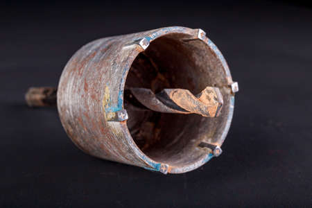 Metal hole saw for drilling into concrete. Accessories for builders to build housing. Dark background.の写真素材