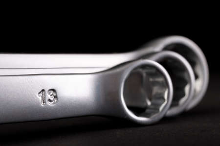 Metal flat keys on a dark table. Accessories for mechanics and builders. Black background.