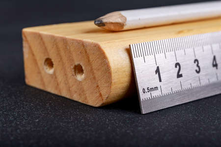A protractor and a metal ruler to measure angles in a carpentry workshop. Accessories for measuring...