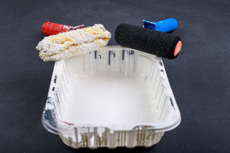 Black and white paint rollers. Painting accessories for home renovation. Dark background.の写真素材