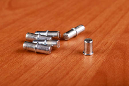 Joining chipboards with the use of specialized metal connectors. Minor carpentry work in the workshop. Light background.の写真素材