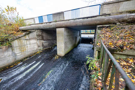 A small dam formed on the river. Road bridge with a small dam. Autumn season.の写真素材