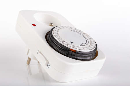 Timer for switching on the electric current. Device for controlling electrical devices. Light background.の写真素材