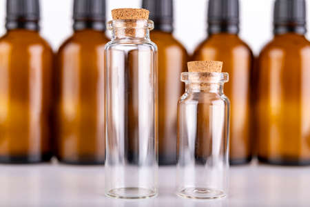 Small glass bottles for storing liquids. Containers used in pharmaceuticals. Light background.の写真素材